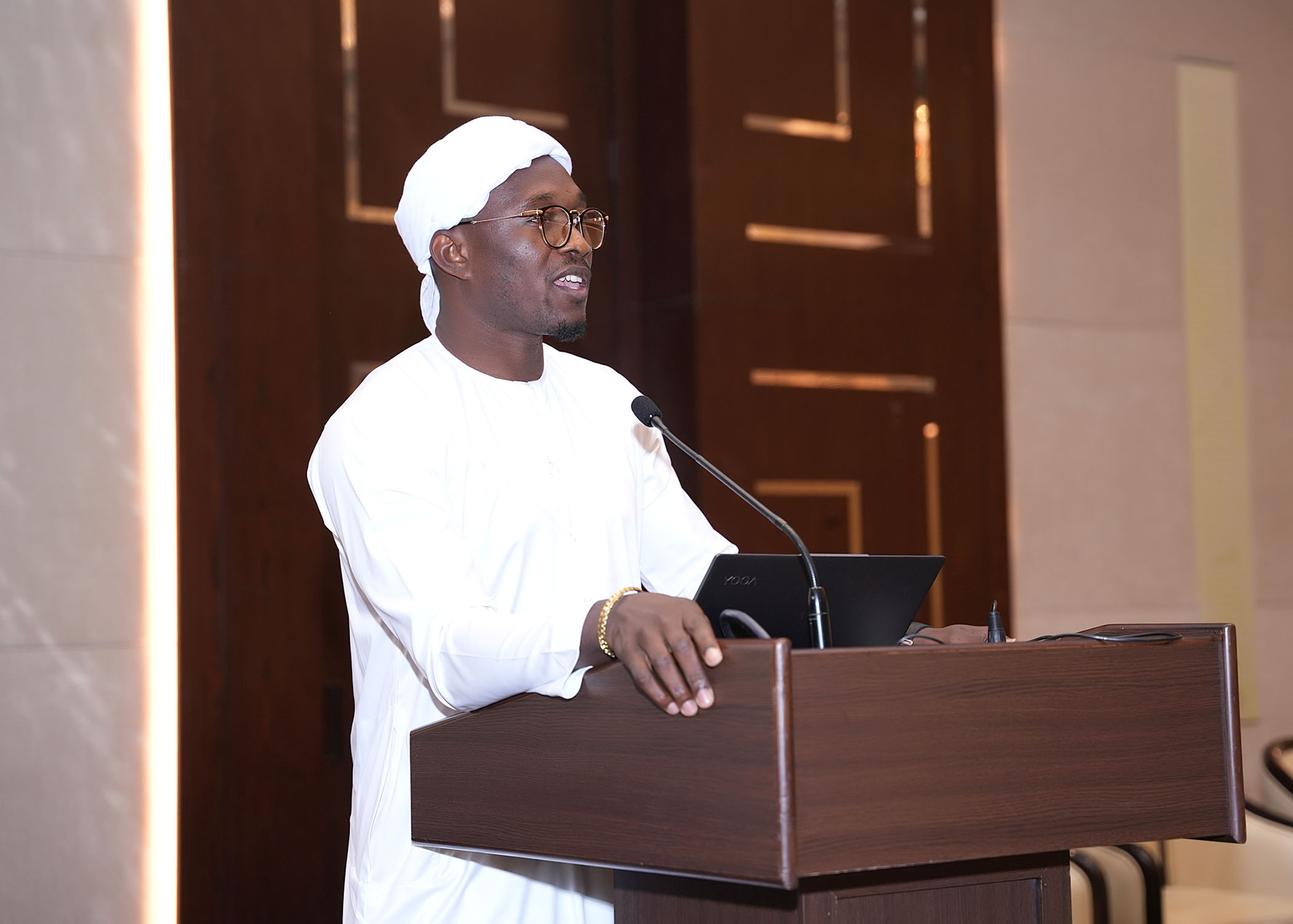Wisdom K. King speaking at a podium